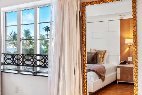 a mirror in a bedroom with a bed and a window at Hotel Ocean in Miami Beach