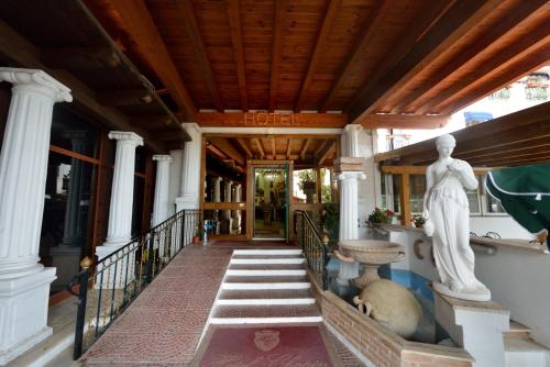 a porch of a house with a statue on the stairs at Hotel Chopin in Fiumicino