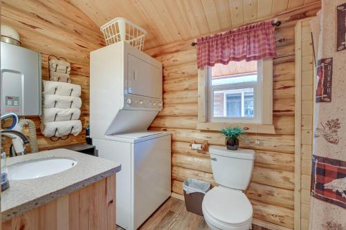 a bathroom with a white refrigerator and a toilet at Charming Soldotna Cabin Near Kenai River Fishing! in Soldotna