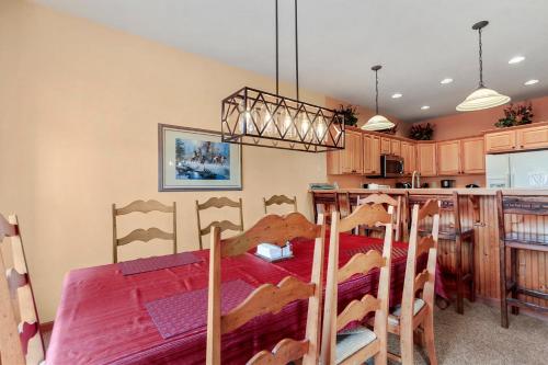 a dining room with a table and a kitchen at Lookout Ridge 45 by Great Western Lodging in Dillon