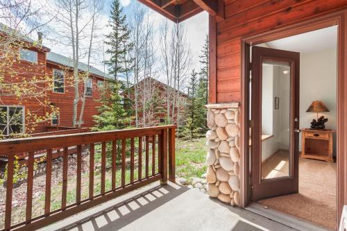an open door to a log cabin with a balcony at Lookout Ridge 45 by Great Western Lodging in Dillon