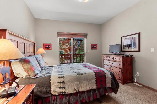 a bedroom with a bed and a dresser and a television at Lookout Ridge 45 by Great Western Lodging in Dillon