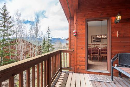 a porch of a log cabin with a dining room at Lookout Ridge 45 by Great Western Lodging in Dillon