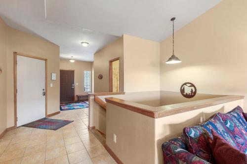 a living room with a couch and a kitchen at Lookout Ridge 45 by Great Western Lodging in Dillon