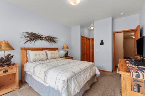 a bedroom with a bed and a desk and a television at Lookout Ridge 45 by Great Western Lodging in Dillon