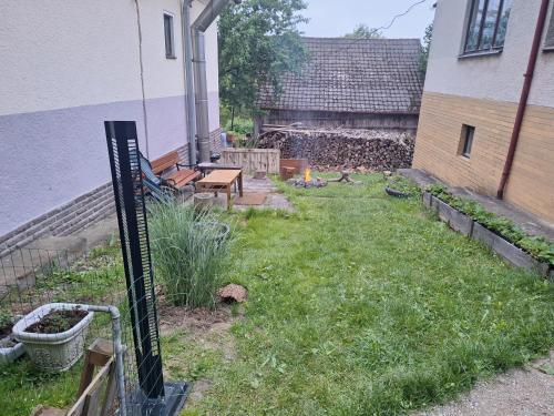 a garden with a sign in the grass at Lesný domček in Hunisky
