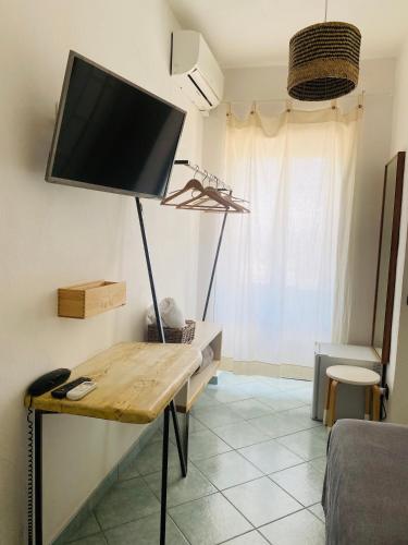 a living room with a flat screen tv on a wall at Black Market Hotel in Ischia