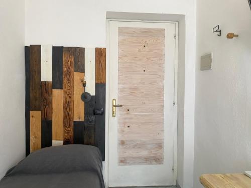 a door to a bedroom with a bed next to it at Black Market Hotel in Ischia