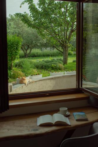 a window with an open book on a table next to a book at IL LILLA in Ankaran