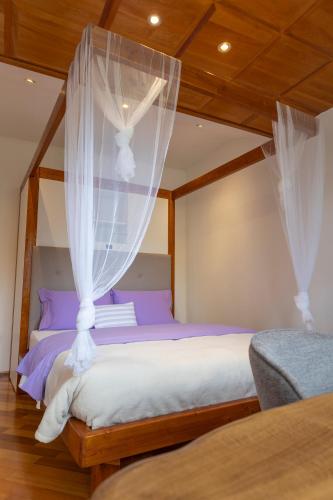 a bedroom with two beds with white drapes at IL LILLA in Ankaran