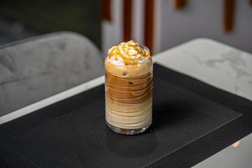 a drink with whipped cream and caramel on a table at Swiss Spirit Second Dammam Industrial City in Dammam