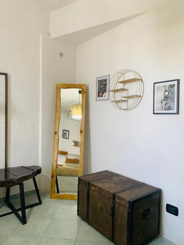 a room with a mirror and a wooden chest at Black Market Hotel in Ischia