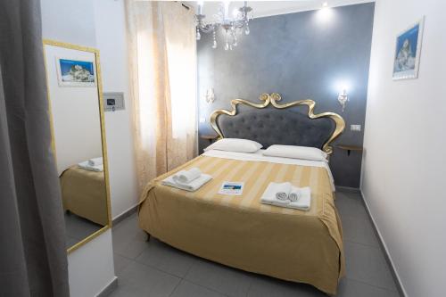 a bedroom with a bed with two towels on it at Residenza Luce Sul Mare in Tropea