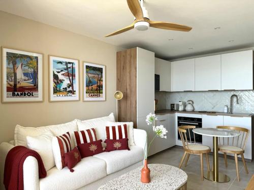un salon avec un canapé blanc et une cuisine dans l'établissement Vistalmar La-Grande-Motte, à La Grande Motte