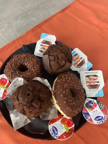 a plate of donuts and cookies on a table at Corte ‘e susu in Nuoro