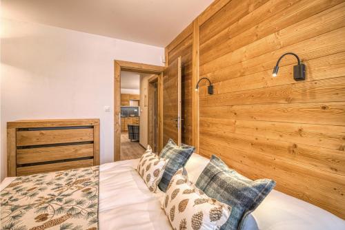 a bedroom with a wooden wall at CHALET MOUNTAIN in Demanovska Dolina