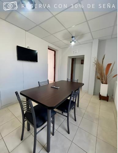 a conference room with a wooden table and chairs at Residencia Céntrica in Chilecito