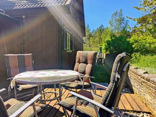 a patio with a table and chairs on a deck at Haus Lagom in Johannishus