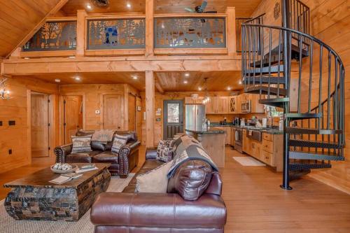 a living room with a spiral staircase in a cabin at The Buckhorn by Stony Brook Cabins in Gatlinburg