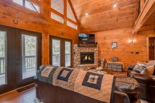 a living room with a couch and a fireplace at The Buckhorn by Stony Brook Cabins in Gatlinburg