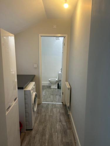 a bathroom with a toilet and a washer and dryer at Brunswick Place XXX in Stoke on Trent