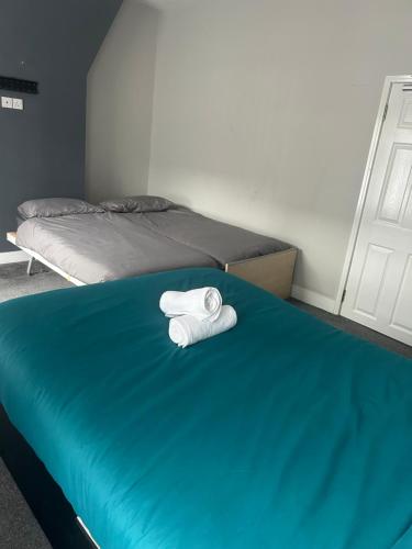 a room with two beds with towels on the bed at Brunswick Place XXX in Stoke on Trent