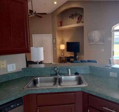 a kitchen with a sink and a counter top at Florida Villa in Kissimmee