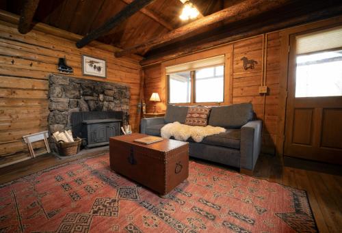 a living room with a couch and a fireplace at Beyul Retreat in Meredith