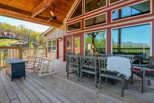 a deck with tables and chairs on a house at Villa Tavia by Stony Brook Cabins in Gatlinburg