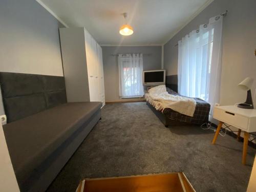 a bedroom with a bed and a desk and a television at Apartment in Herne 4 in Herne