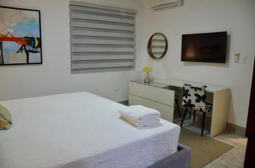 Ένα ή περισσότερα κρεβάτια σε δωμάτιο στο SOHA SUITES II