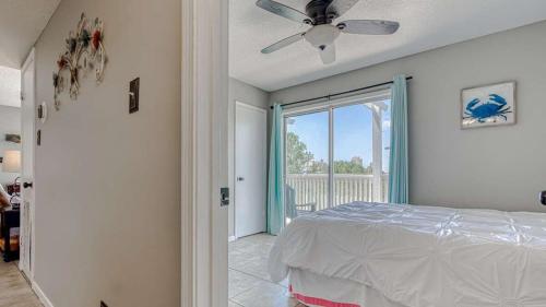 a bedroom with a bed and a ceiling fan at Romar Village 322- short walk to beach pool in Orange Beach