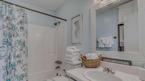 a white bathroom with a sink and a shower at Romar Village 322- short walk to beach pool in Orange Beach