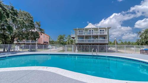 a large swimming pool in front of a building at Romar Village 322- short walk to beach pool in Orange Beach