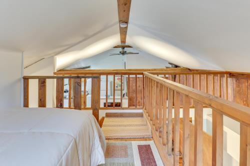 a bedroom with a bed and a staircase with a ceiling at Chagrin Falls Home about 2 Mi to Town! in Chagrin Falls