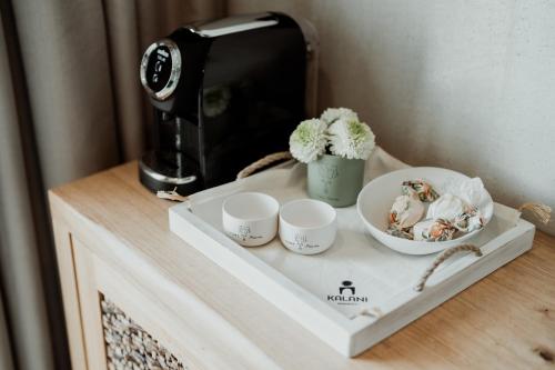 a table with a tray with cups and a toaster at Kalani Residence in Keramotí