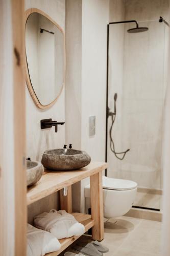 a bathroom with two sinks and a mirror at Kalani Residence in Keramotí