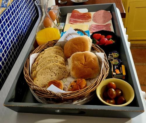 a tray with a basket of bread and other foods at Cortijo naturista con vistas-clothing optional in Oria