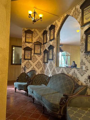 a living room with a couch and a window at El Monasterio in San Joaquín