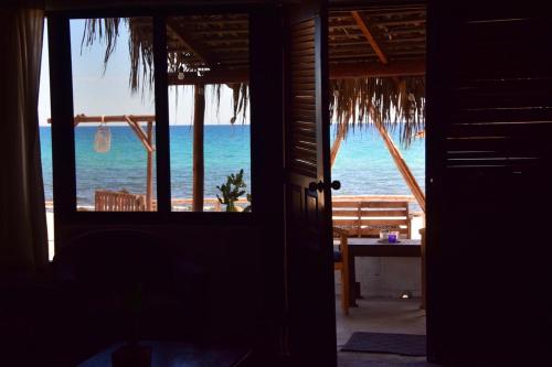 a room with a view of the ocean from a beach at RUSTICO LOUNGE-Property in front of the beach in San José del Cabo