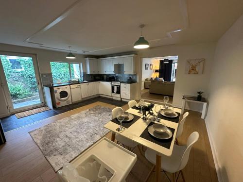 a living room with a table and chairs and a kitchen at 1 bed annex with extra sofa bed ideal for families and business guests in Littleport