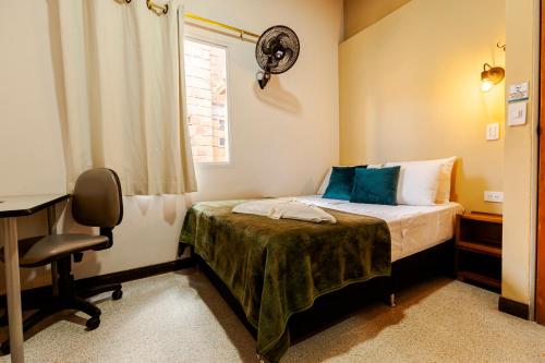 Una cama o camas en una habitación de Poblado Guest House