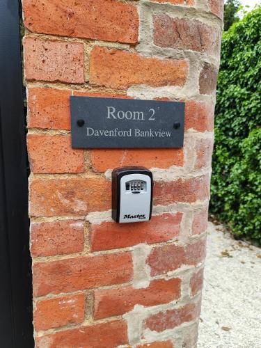 a brick wall with a clock on it at Cotswold Bankview in Moreton in Marsh