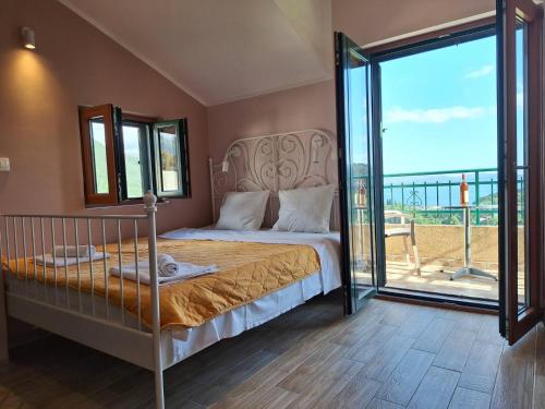 a bedroom with a bed and a large window at Holiday Home Sunny Hill in Kamenari
