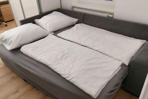 a bed with two pillows on top of it at Appartement Top 4 - Premium in Linz