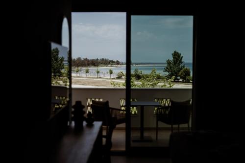 a room with a table and a view of the ocean at Kalani Residence in Keramotí
