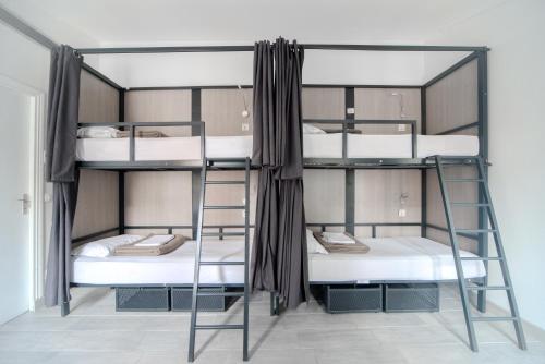 a room with three bunk beds in a hostel at City Inn Paris in Paris