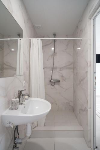 a white bathroom with a sink and a shower at Edelweiss New 2026 Солотвино in Solotvyno