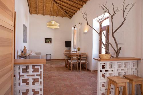 a living room with a table and a dining room at Casa da Portela, Algarve Tradicional - Geoparque Algarvensis in São Bartolomeu de Messines