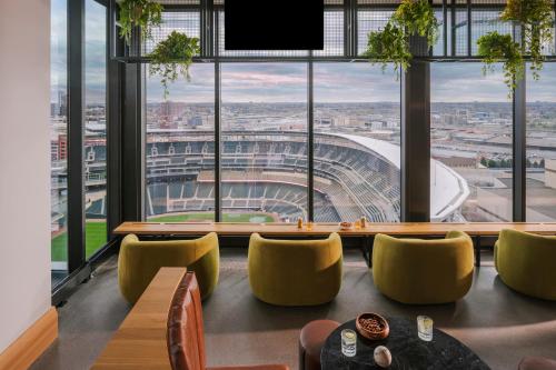 a restaurant with a view of a stadium through windows at Sonder at North Loop Green in Minneapolis